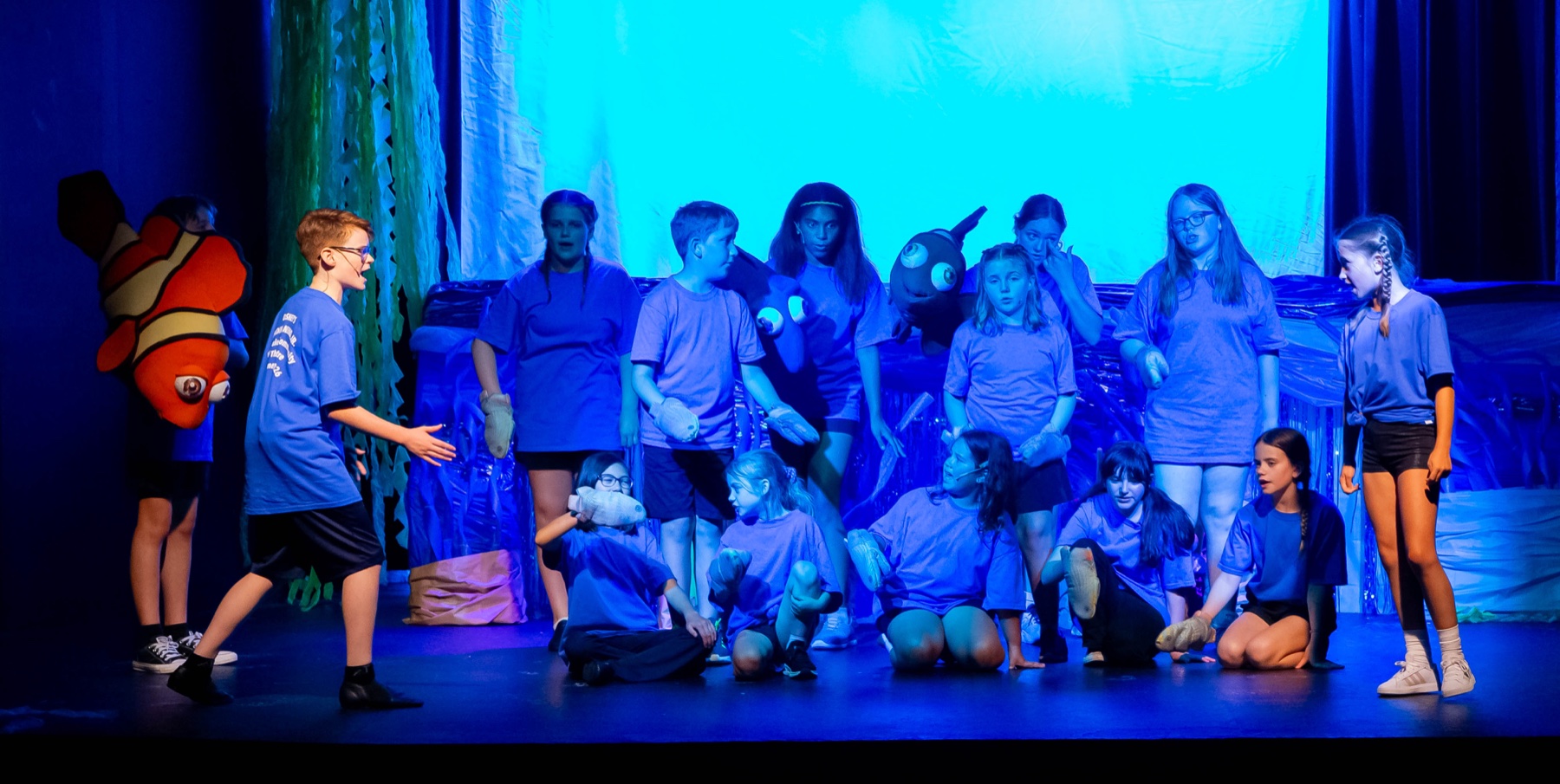 Young performers sing together during Finding Nemo JR.