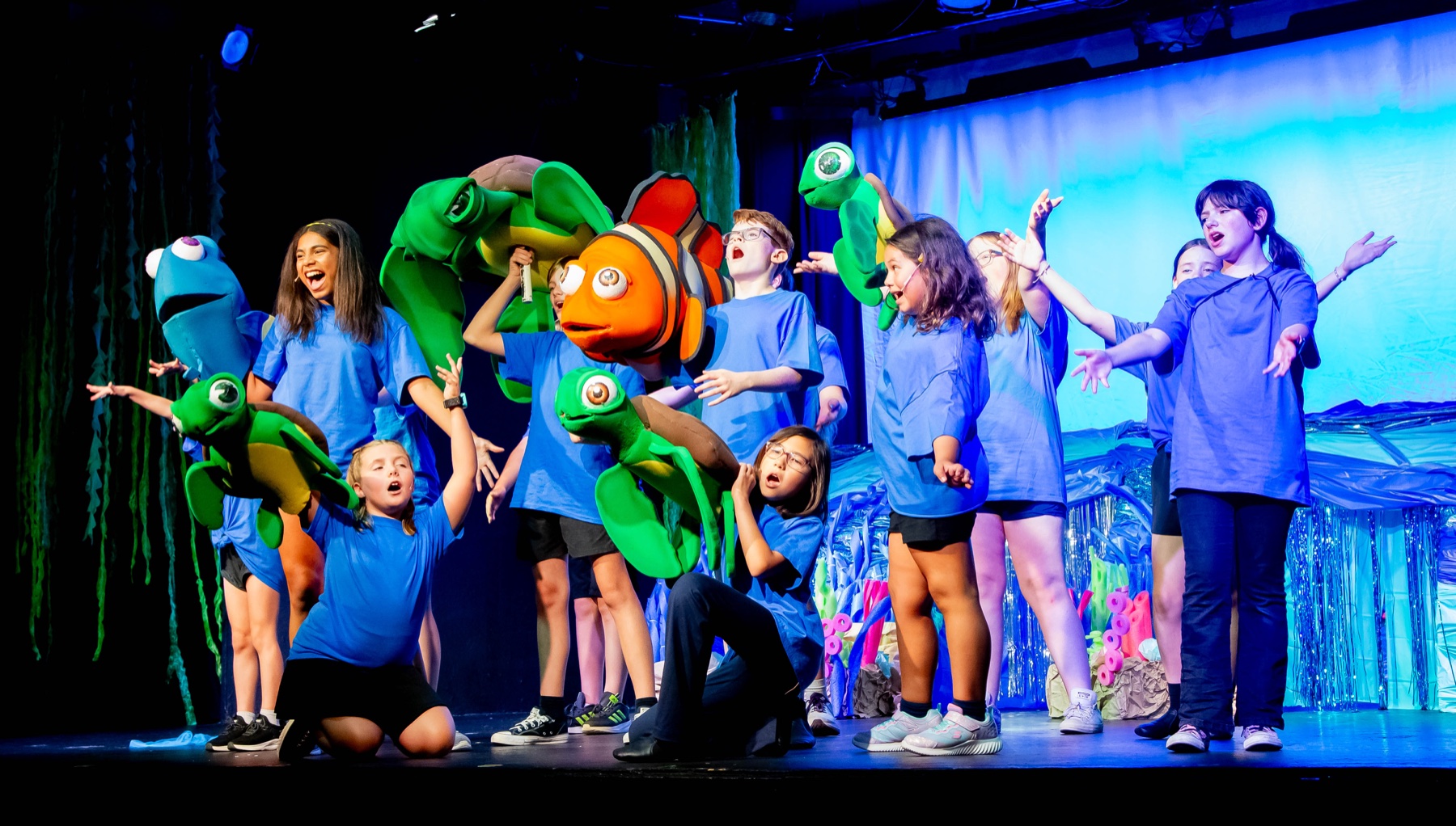 The Finding Nemo JR. company performs with colorful fish and sea-turtle puppets